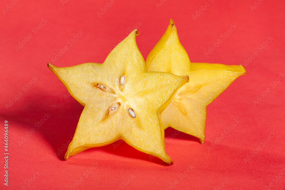 sliced carambola starfruit on red background sliced carambola starfruit on red background