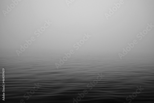 Moving ocean waves in fog black and white. 