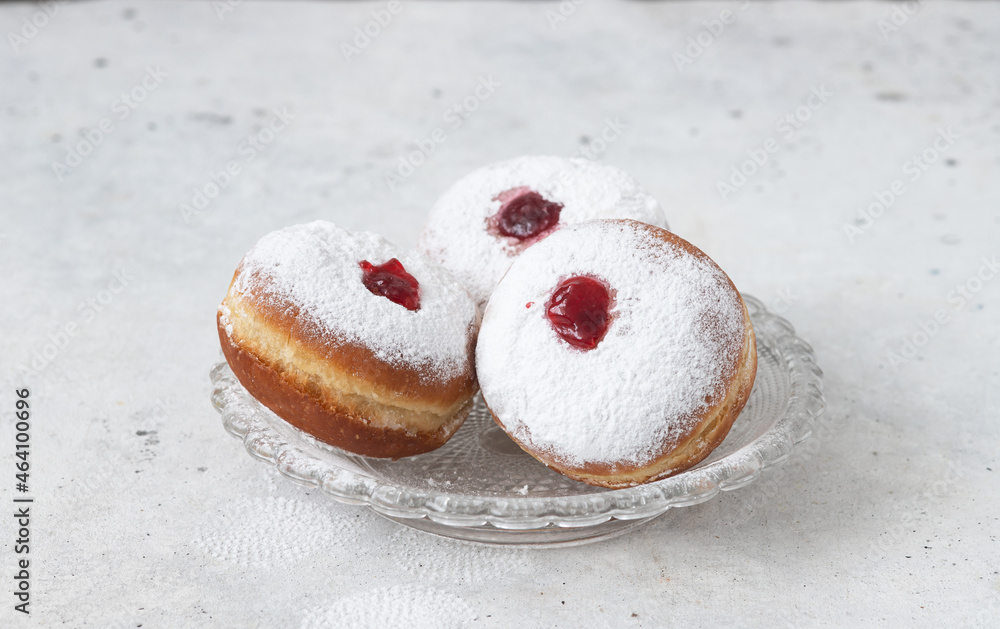 Tasty donuts with jam on background - Hanukkah celebration concept Tasty donuts with jam on background - Hanukkah celebration concept