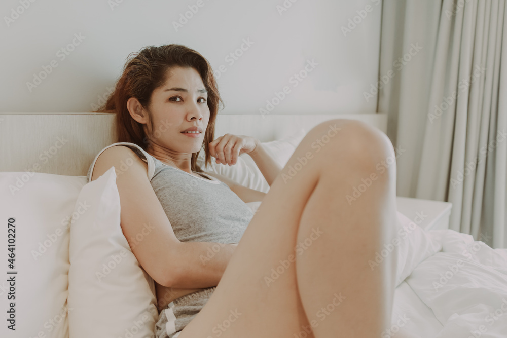 Sexy Asian woman feels relax on the bed alone in the room. Sexy Asian woman feels relax on the bed alone in the room.