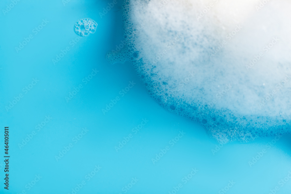 Soap foam on a blue background close-up. Global Handwashing Day.