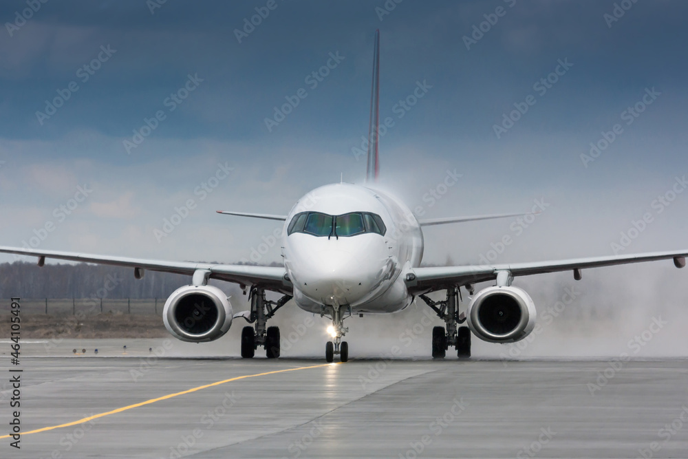 Close-up a passenger aircraft taxiing through a water salute in honor of the first visit Close-up a passenger aircraft taxiing through a water salute in honor of the first visit