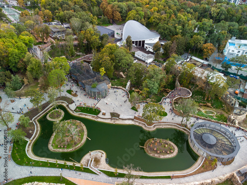 Autumn city aerial look down view on Kharkiv zoo lake surrounded by greenery and walking paths. Recreation area in Ukraine photo