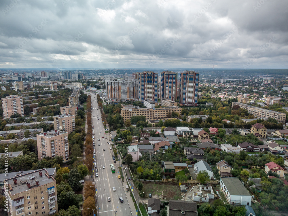 Obraz premium Cityscape aerial with dramatic clouds. Kharkiv city Pavlovo Pole district, view on Nauky ave with multistory modern high residential buildings