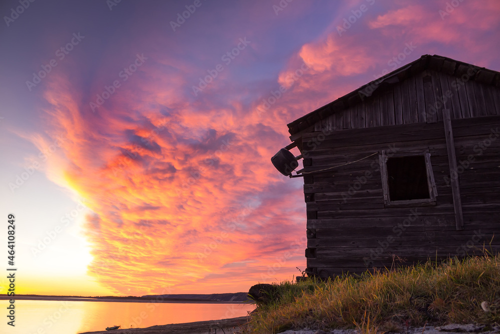 Abandoned old wooden house. Sunset