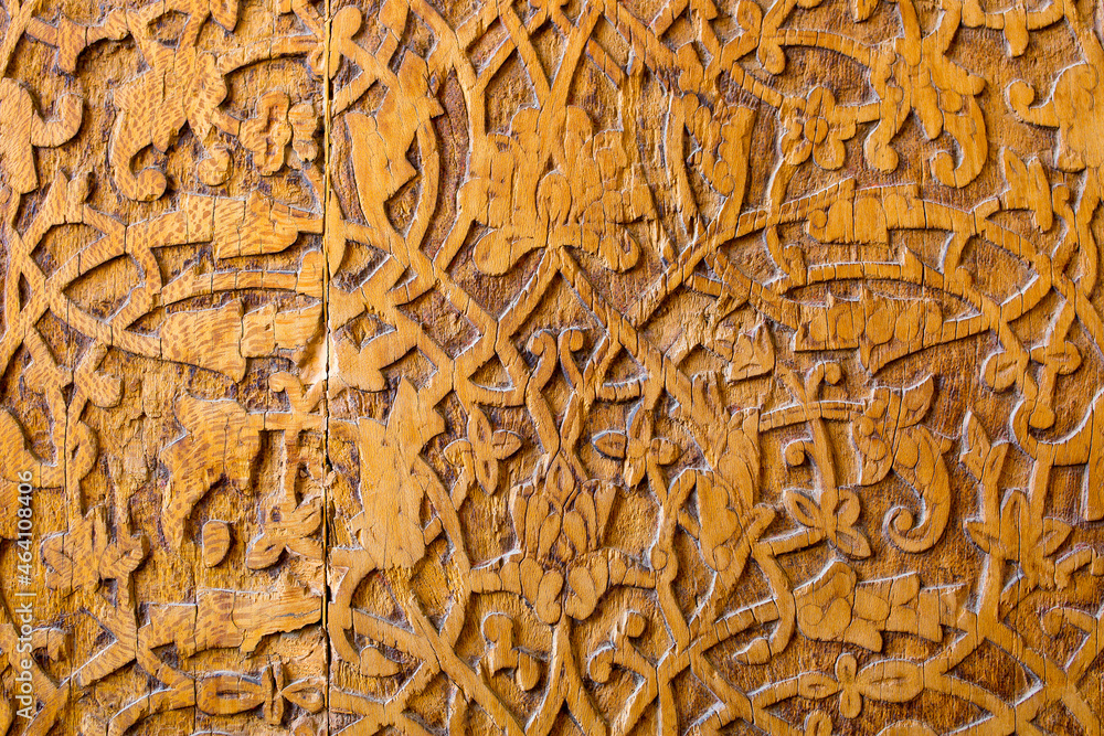 Wooden carved antique door as background ancient vintage pattern of Asian peoples, ancient east Kazakhstan Uzbekistan