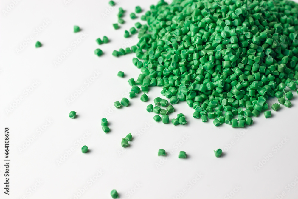 Green granules of polypropylene or polyamide on a white background.  Plastics and polymers industry. Copy space. Stock-Foto | Adobe Stock