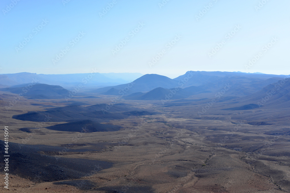 Mountain landscape, desert. Makhtesh Ramon Crater in Negev desert, Israel. Stony desert panoramic view. Unique relief geological erosion land form. National park Makhtesh Ramon or Ramon Crater
