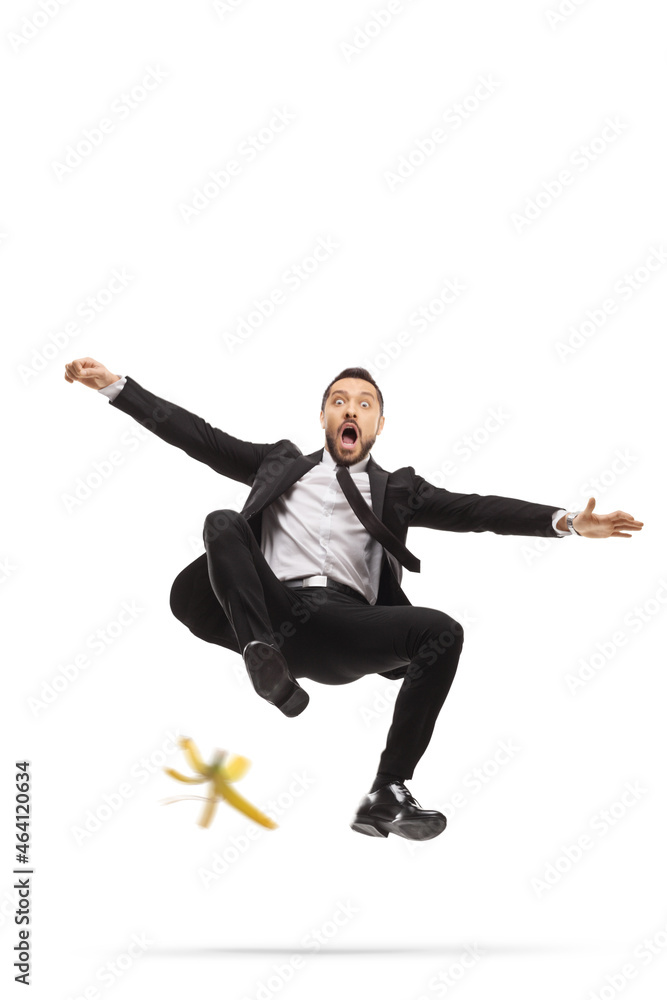 Businessman falling down and slipping on a banana peel Businessman falling down and slipping on a banana peel