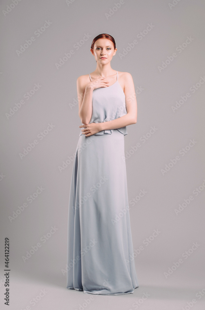 Sensual portrait of beautiful woman in blue evening dress. Natural looking makeup and stylish hairdo. Happy smiling lady in elegant attire. Sensual portrait of beautiful woman in blue evening dress. Natural looking makeup and stylish hairdo. Happy smiling lady in elegant attire.