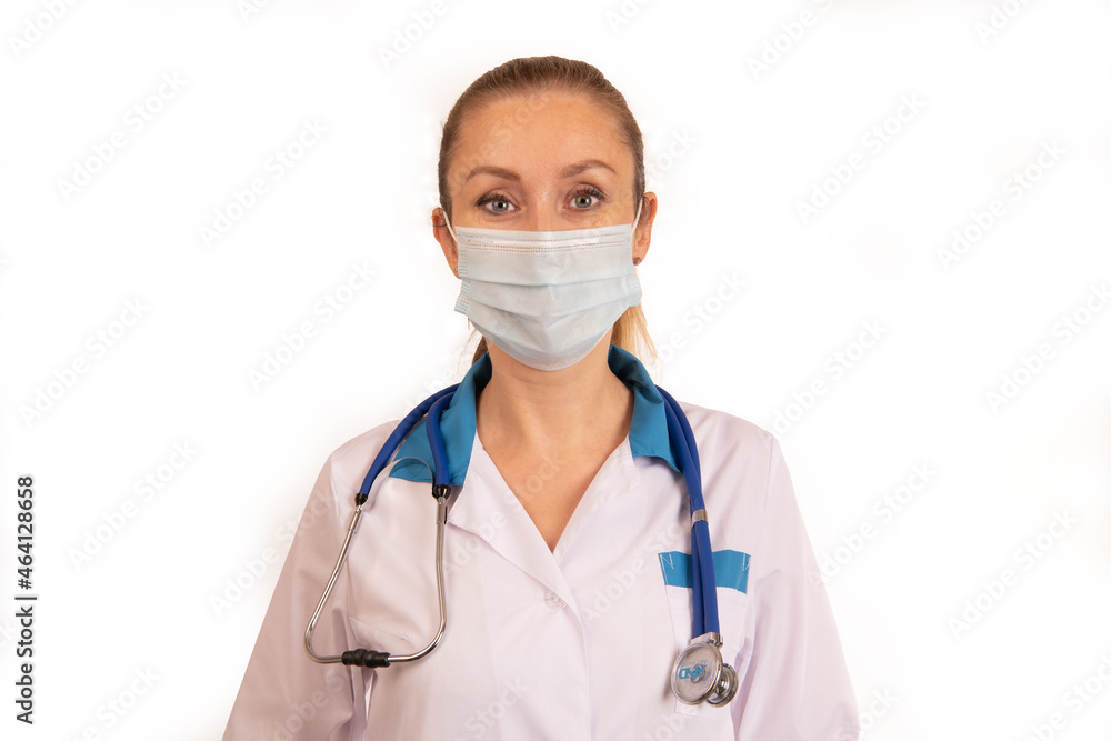 A young girl doctor on a white background in a white coat with a stethoscope on her neck and smoothly combed back hair A young girl doctor on a white background in a white coat with a stethoscope on her neck and smoothly combed back hair