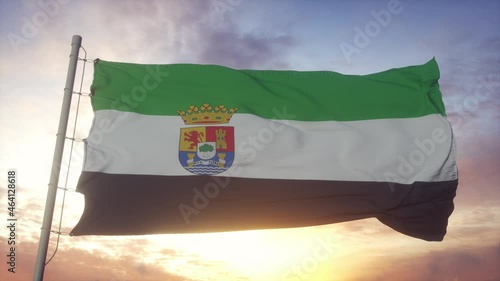 Extremadura flag, Spain, waving in the wind, sky and sun background photo