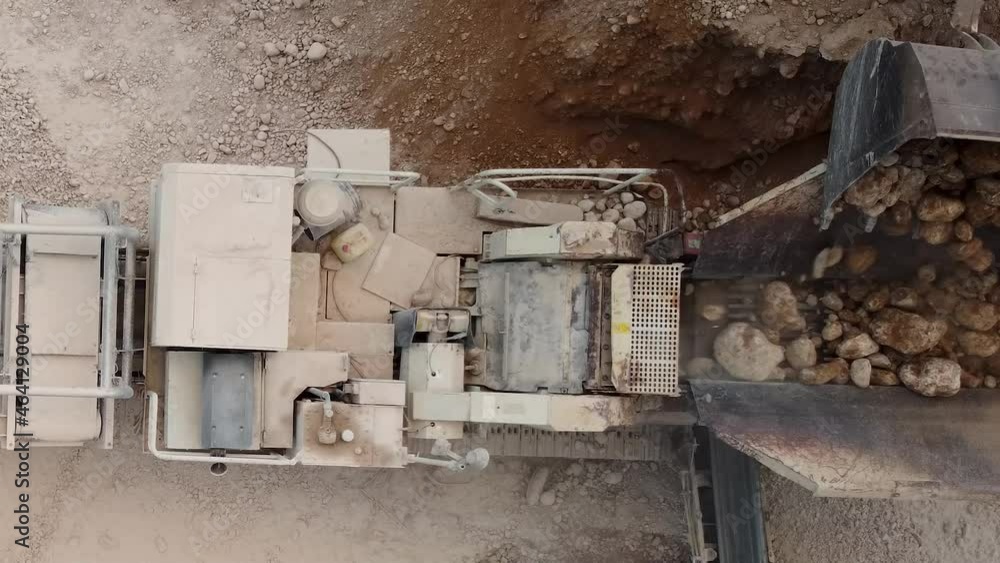 Top view of a arid crusher working in a quarry. Construction works concept Top view of a arid crusher working in a quarry. Construction works concept