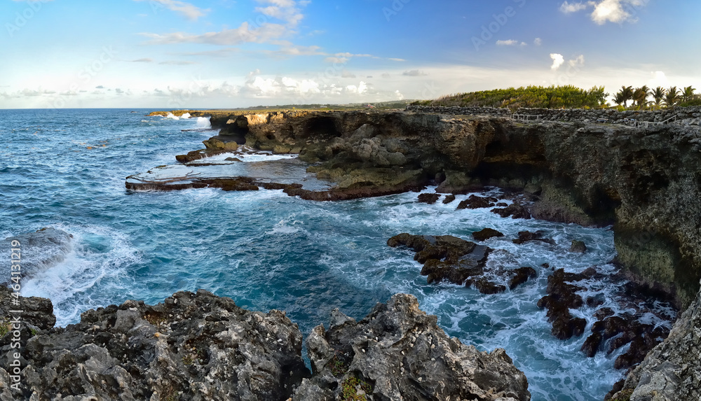 Rough ocean waves crashing against the rocky cliffs of North Point, Barbados, Caribbean