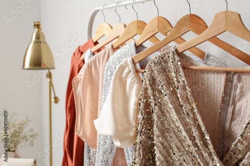 Foto Rack with stylish clothes near light wall