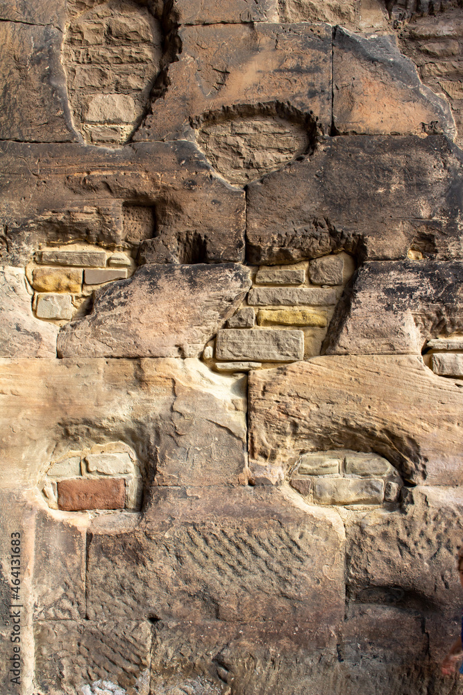 Abstract texture background of an ancient fortified stone wall surface with minor modern repair in places