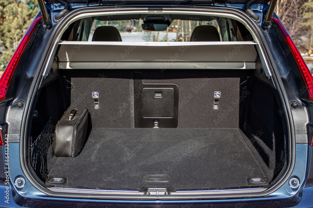 Huge, clean and empty car trunk in interior of a modern compact suv. Rear view of a SUV car with open trunk. Car trunk interior.