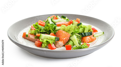 Tasty salad with salmon and vegetables in plate on white background