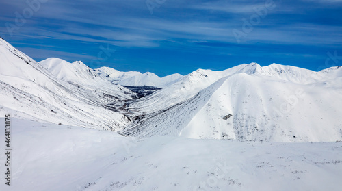 View of the mountain landscape under the blue sky after spring snowfall. © okyela