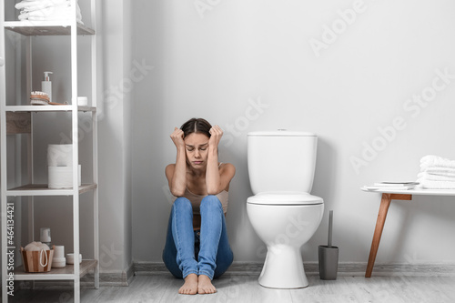 Young woman near toilet bow...