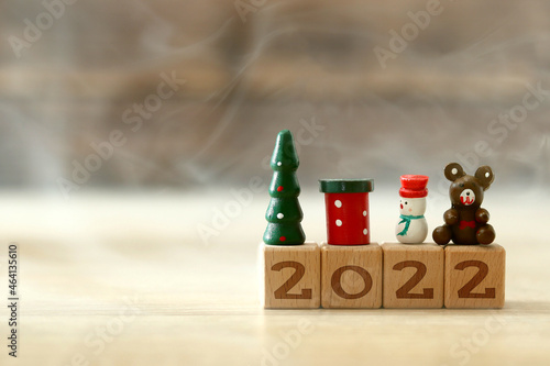 Christmas toys on wooden cubes with the inscription 2022, new year