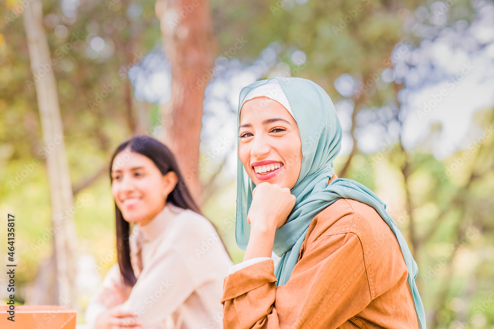 Fototapeta premium muslim spanish woman with hijab, happy celebration Christmas party with multiethnic group