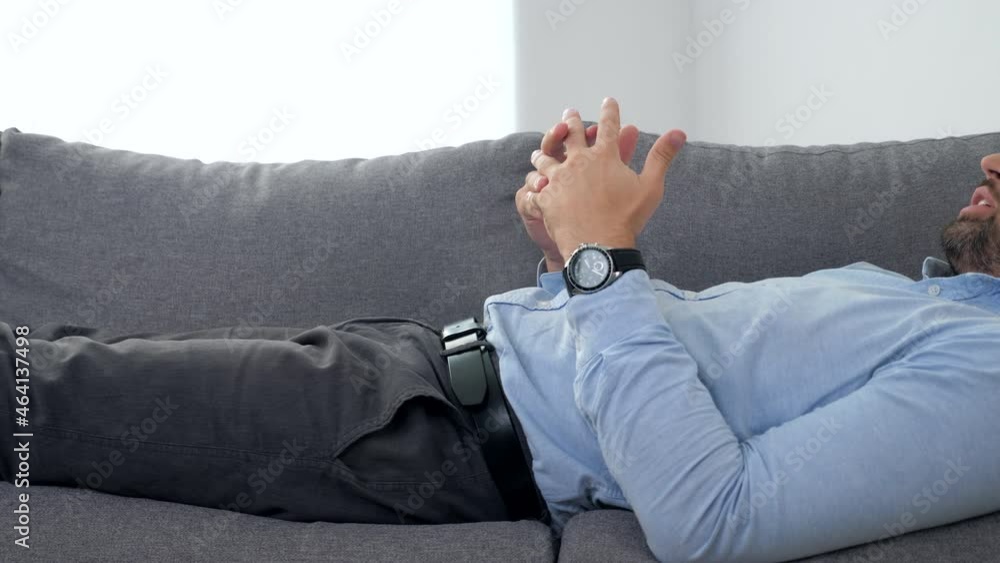 Sad adult bearded man with mental health problems after coronavirus lying on couch talking to psychologist. Doctor psychotherapist listens patient at psychotherapy session in medical clinic hospital Sad adult bearded man with mental health problems after coronavirus lying on couch talking to psychologist. Doctor psychotherapist listens patient at psychotherapy session in medical clinic hospital