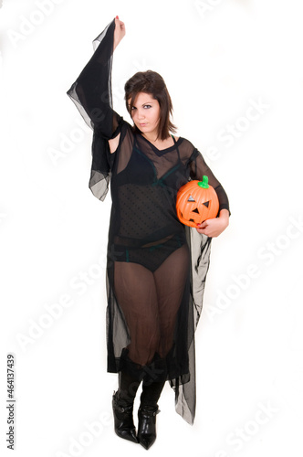 sensual woman dressed in black as a sexy witch for Halloween celebration