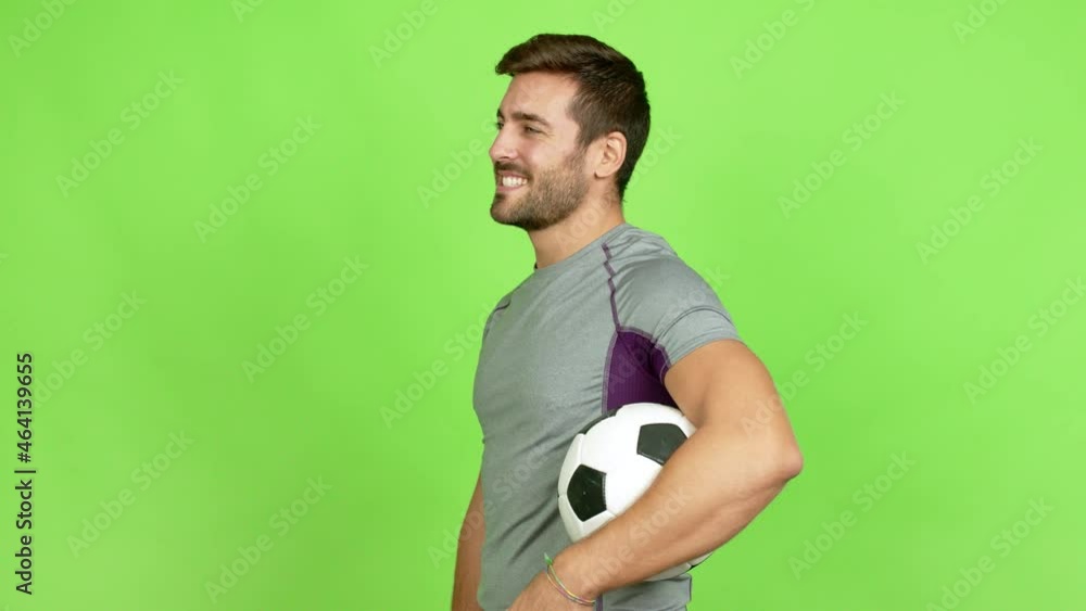 Handsome man playing futbol in lateral position over isolated background Handsome man playing futbol in lateral position over isolated background