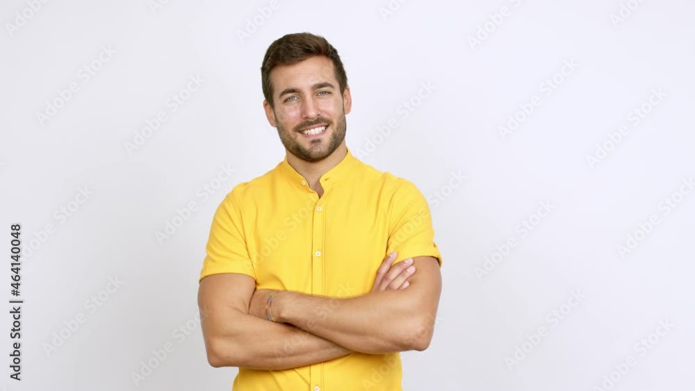 Handsome man keeping the arms crossed in confident expression over isolated background Handsome man keeping the arms crossed in confident expression over isolated background
