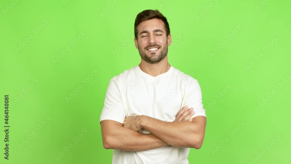 Handsome man keeping the arms crossed in confident expression over isolated background Handsome man keeping the arms crossed in confident expression over isolated background
