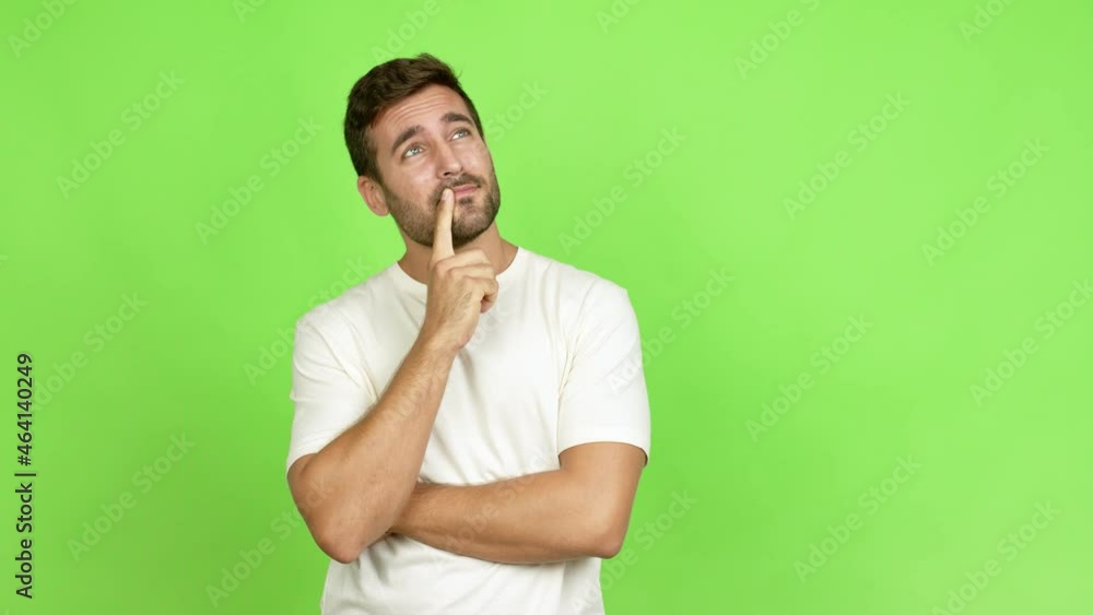 Handsome man standing and thinking an idea pointing the finger up over isolated background Handsome man standing and thinking an idea pointing the finger up over isolated background