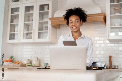 A freelancer prints a message to clients on a social network. Student online training. A woman surfing the internet. The blogger is working on a laptop. Workplace at home.