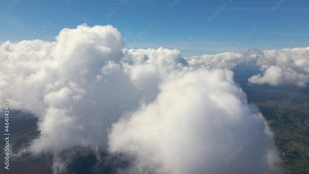 Aerial view from airplane window at high altitude of earth covered with puffy cumulus clouds forming before rainstorm. Aerial view from airplane window at high altitude of earth covered with puffy cumulus clouds forming before rainstorm.