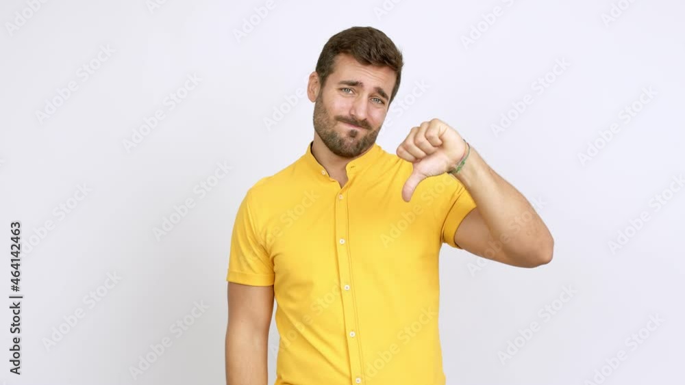Handsome man doing bad signal over isolated background Handsome man doing bad signal over isolated background