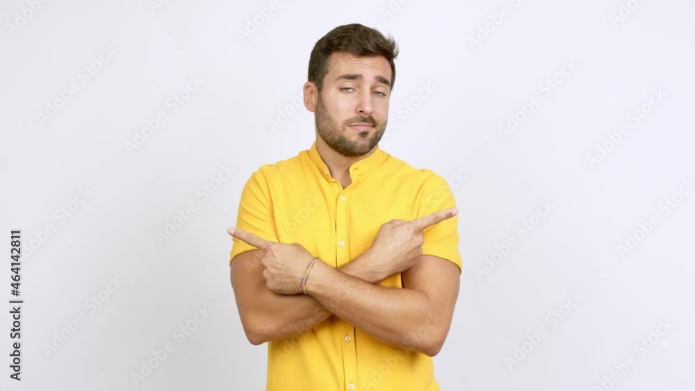 Handsome man pointing to the laterals having doubts over isolated background