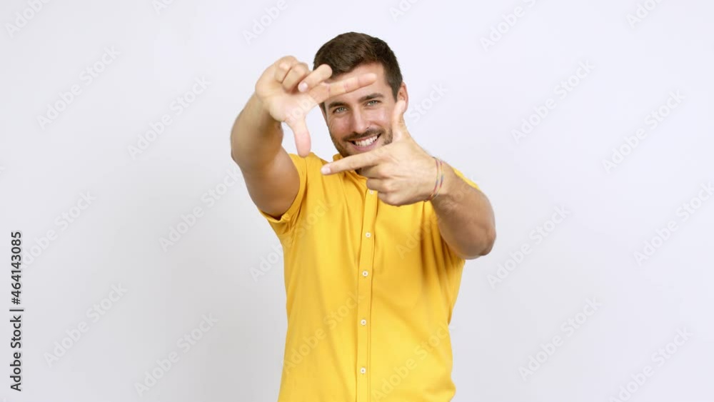 Handsome man focusing with fingers over isolated background Handsome man focusing with fingers over isolated background