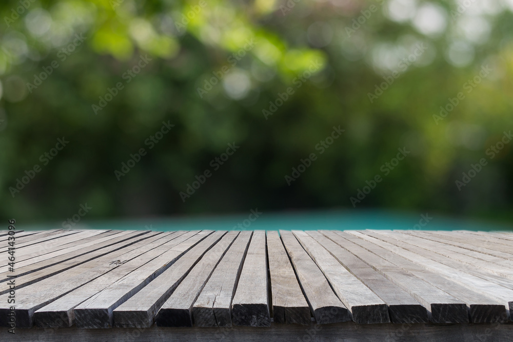 Empty old wooden table in front of blurred tree background in the forest with bokeh of sunlight. Can be used for display or montage for show your products. Empty old wooden table in front of blurred tree background in the forest with bokeh of sunlight. Can be used for display or montage for show your products.