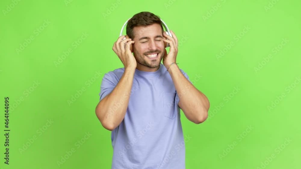 Handsome man unhappy and holding a piggybank over isolated background Handsome man unhappy and holding a piggybank over isolated background