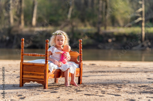 A Lovely Blonde Child Enjoys An Spring Day Outdoors photo