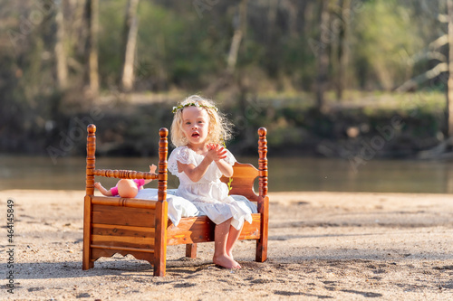 A Lovely Blonde Child Enjoys An Spring Day Outdoors photo