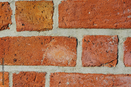 Close up of textured red brick wall background or backdrop, rectangular red terracotta bricks laid out as pattern, architectural structure for old rough building