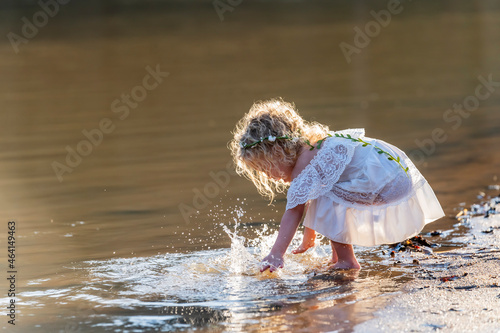 A Lovely Blonde Child Enjoys An Spring Day Outdoors photo