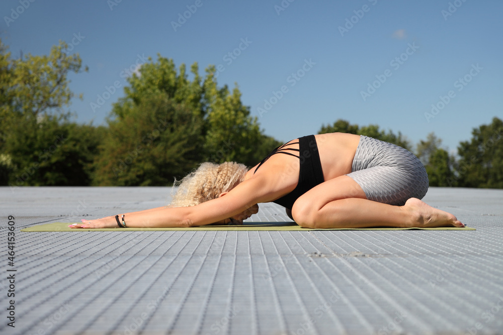 Beautiful young woman doing yoga exercise