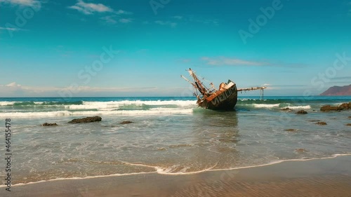 Abandoned Rusty Ship on the Shore of the Pacific Sea photo