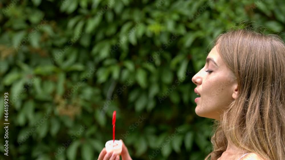 A teenage lady making bubble with a blow and watch them in the air. An innocent lady with a happy expression smile after the bubble she make. A childish lady playing with the bubble. A teenage lady making bubble with a blow and watch them in the air. An innocent lady with a happy expression smile after the bubble she make. A childish lady playing with the bubble.