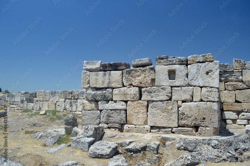 Ruins of ancient column and construction blocks of antique city Hierapolis, in Pamukkale, Turkey