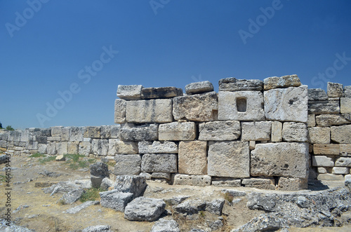 Ruins of ancient column and construction blocks of antique city Hierapolis, in Pamukkale, Turkey