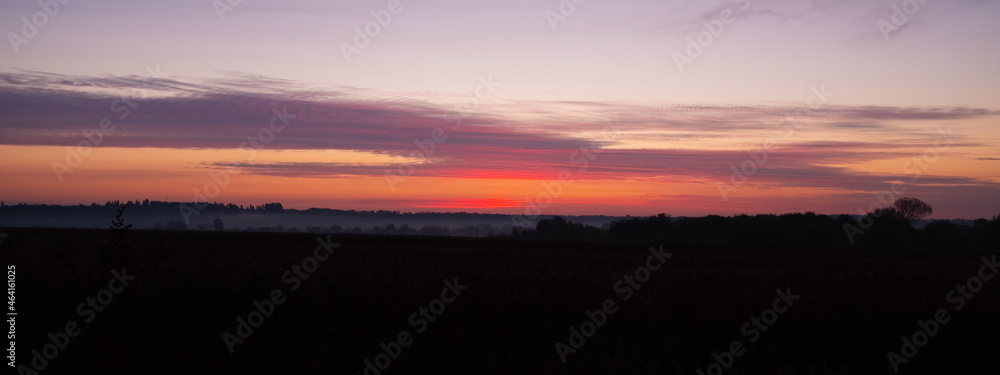 beautiful morning sky sunrise on the autumn field.