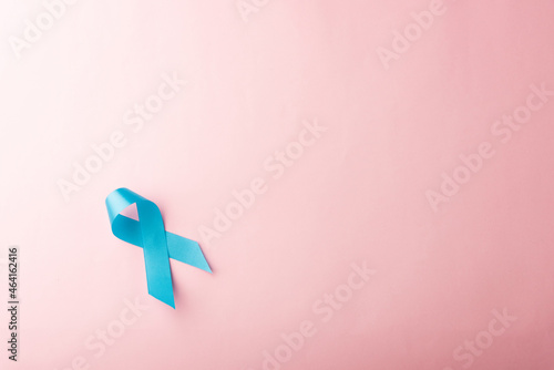 November light blue ribbon, studio shot isolated on pink background, Prostate cancer awareness month, men's health concept photo